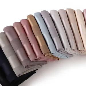 Detailed view of soft imitation silk long scarf with wide stripes and hollow design.