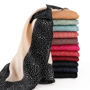 Details of pleated women scarf with black border polka dot print and multi-color stacked display.