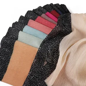 Detailed view of pleated scarf with polka dot border, lightweight breathable texture fabric.