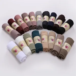 Detailed view of rolled crinkled polyester solid color hijab and long scarves in multi colors.