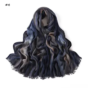 Details of gradient blue wrinkled scarf with soft cotton fabric and stylish fringe edges.