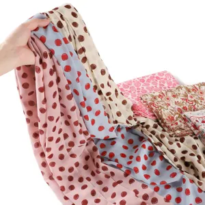 Detailed view of the soft chiffon scarf featuring chic polka dot and floral prints.