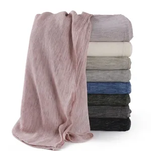 Soft rayon crinkle scarf detail showing fine texture and rolled edges in multi-color stacked view.