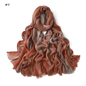 Gradient crinkle rayon scarf detail showing soft orange and grey tones with delicate fringes.