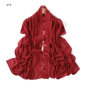 Detailed view of the red chiffon scarf featuring exquisite floral lace embroidery and lightweight fabric.