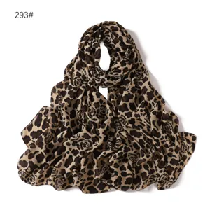 Leopard print chiffon scarf detail view, soft fabric texture and abstract floral pattern closeup.