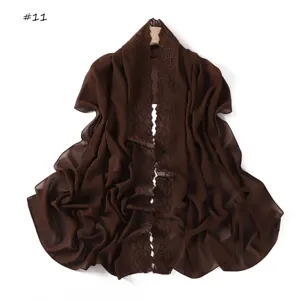 Brown chiffon scarf with delicate floral embroidery edge, elegant detail display for women.