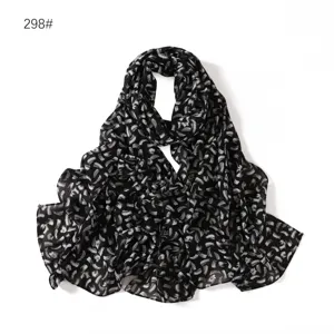 Black and white abstract pattern chiffon scarf detail showing soft lightweight fabric texture.