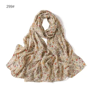 Floral print chiffon scarf detail showing soft fabric texture and delicate abstract flower pattern.