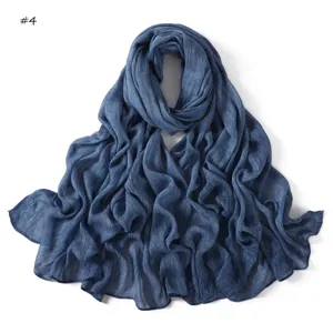 Blue crinkle rayon scarf detail shot, showing soft texture and rolled edges clearly.