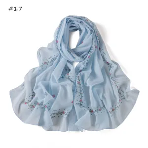 Light blue floral chiffon scarf detail showing digital printed roses, elegant summer style.