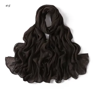 Dark brown crinkled rayon scarf detail showing soft texture and rolled edges for daily wear.