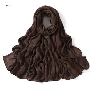 Detailed view of soft crinkled dark brown rayon scarf with rolled edges and fine texture.