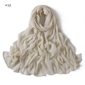 Detailed view of solid color crinkled cotton blend long scarf with rolled edges, soft fabric.