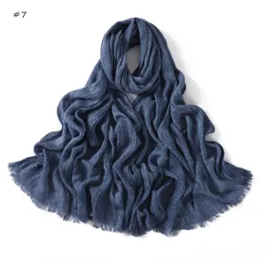 Detailed view of the dark blue crinkled slub cotton scarf showing soft frayed texture.