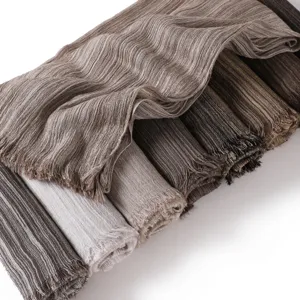 Detailed view of vintage striped cotton linen scarf with frayed edges and soft texture.