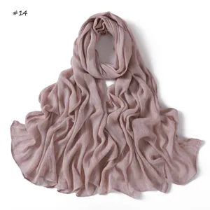 Detail view of dusty pink crinkle rayon hijab scarf, featuring fine texture and rolled edges.