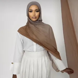Vue de détail rapprochée du foulard hijab en modal dégradé élégant avec tenue blanche assortie.