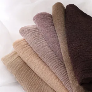 Soft pleated hijab scarf detail showing bark wrinkle texture and elastic polyester fabric.