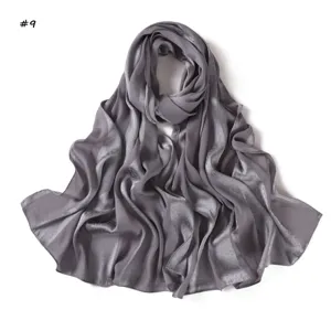 Detail view of a grey satin imitation silk long scarf featuring subtle jacquard leopard pattern.