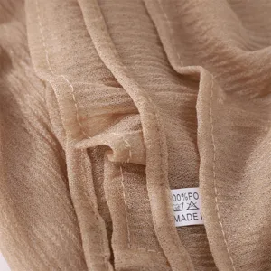 Detailed close-up shot of plain crinkled lightweight polyester scarf showing soft texture.