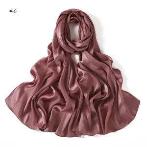 Detailed view of a solid color satin imitation silk long scarf shawl in elegant dusty pink.