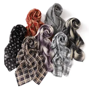 Detailed view of multiple retro plaid and polka dot chiffon scarves, lightweight and stylish.