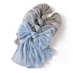 Close up view of glossy crinkled satin scarf detail, soft draping fabric texture