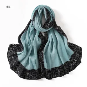 Detailed view of the pleated long scarf featuring a stylish black polka dot border design.