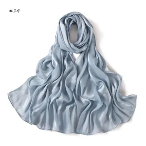 Delicate light blue satin silk long scarf detail showing soft breathable textured drape.