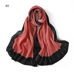 Women's pleated long scarf with black polka dot border, versatile pink design detail.