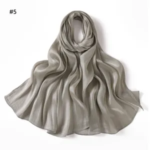 Detail view of the solid color shiny satin scarf, showing the soft draped texture and glossy finish.