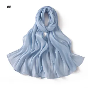 Light blue shiny satin wrinkled scarf detail, soft draping long shawl and headscarf fabric.