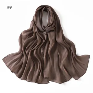Detail shot of the shiny satin long scarf showing soft draped texture and elegant dark brown color.