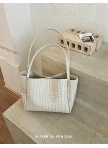 Detailed view of women retro woven tote bag, chic beige shoulder bag for daily commuting style.