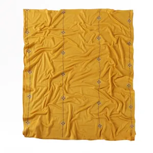 Detailed view of yellow mercerized cotton long scarf featuring rhinestone clover line patterns.
