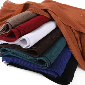 Detail view of multi-color pleated chiffon hijab scarf with sparkling metallic gold glitter details.