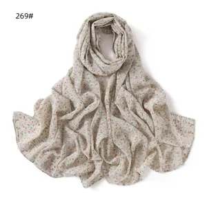Detail view of the floral chiffon scarf showing soft fabric texture and elegant drape.