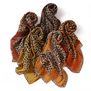 Detailed view of the retro leopard print pleated scarf, soft cotton-linen texture.