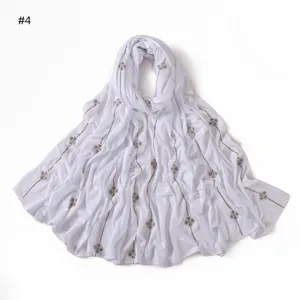 Detailed close-up view of white rhinestone clover line scarf fabric texture and sparkle design.