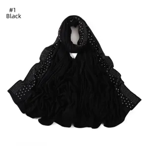 Detail view of black elastic jersey hijab scarf with sparkling rhinestone dot embellishments.