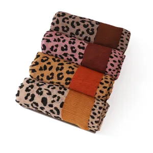 Leopard print crinkled scarf detail view, showing soft texture and contrast color block design.