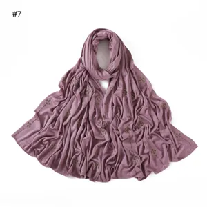 Mercerized cotton solid color jersey long scarf with rhinestone clover pattern detail view.