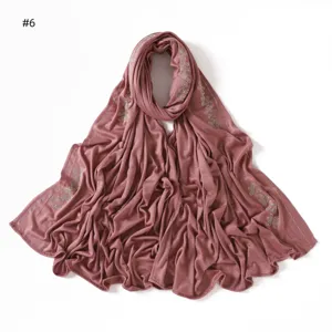 Detail view of a stylish mercerized cotton jersey scarf with rhinestone line floral patterns.