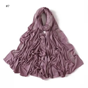Close-up view of purple jersey scarf featuring delicate rhinestone flower details and soft texture.