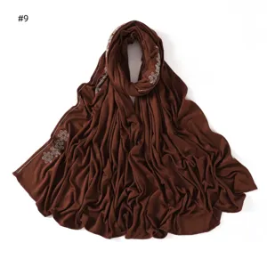 Brown cotton jersey hijab scarf with rhinestone flower detailing, soft & breathable.