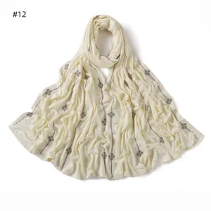 Beige cotton modal scarf detail featuring rhinestone four leaf clover lines pattern.