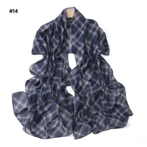 Detailed view of the blue plaid chiffon scarf, lightweight fabric and delicate drape.