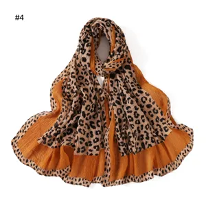 Close-up details of vintage colorful leopard print pleated scarf fabric and textured design.