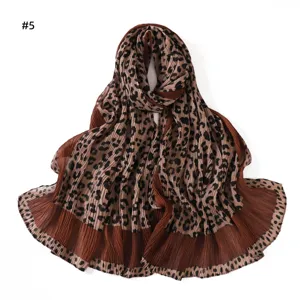 Detailed view of the pleated leopard print long scarf, showing soft texture and unique folds.